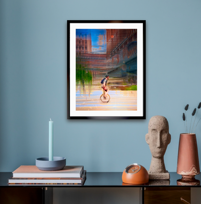 Circus Life person cycling on a unicycle  past Oslo Rådhus Oslo city on there daily commute — ICM photography cycling wall art print by Douglas Carr at Oslo Art Prints. Free worldwide shipping.